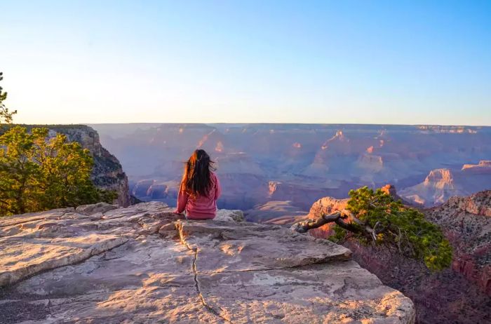 A woman enjoying the view of the Grand Canyon