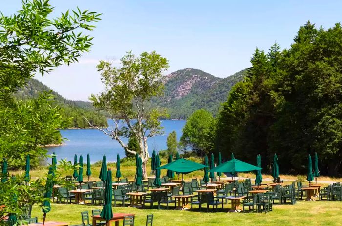 Outdoor dining area with a view of Jordan Pond at Acadia National Park in Maine. This image was captured before the restaurant opened.