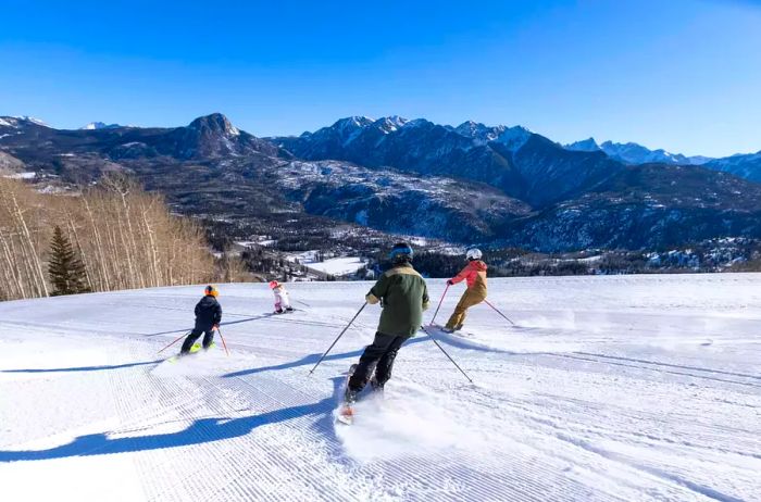 A family of four enjoying skiing on Purgatory Mountain in Durango, Colorado