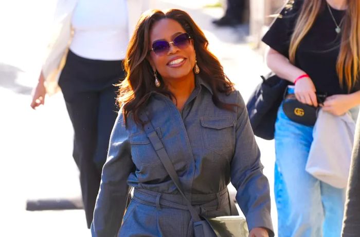 Oprah sporting a stylish street outfit with a crossbody bag