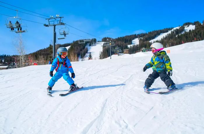 Two young children taking their first skiing lessons