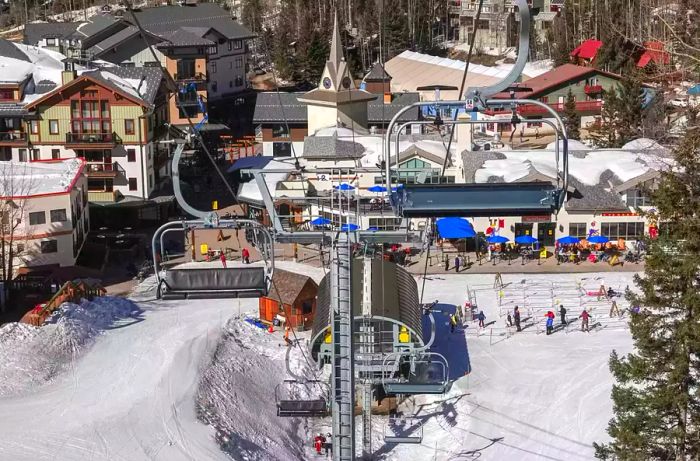 Skiers and snowboarders enjoying the base of the Taos ski resort in New Mexico