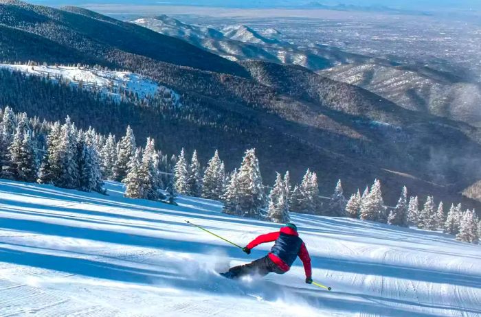 A skier gracefully descending a snowy slope in Santa Fe