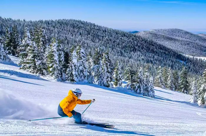 A skier gracefully descending a snowy mountain in Santa Fe 