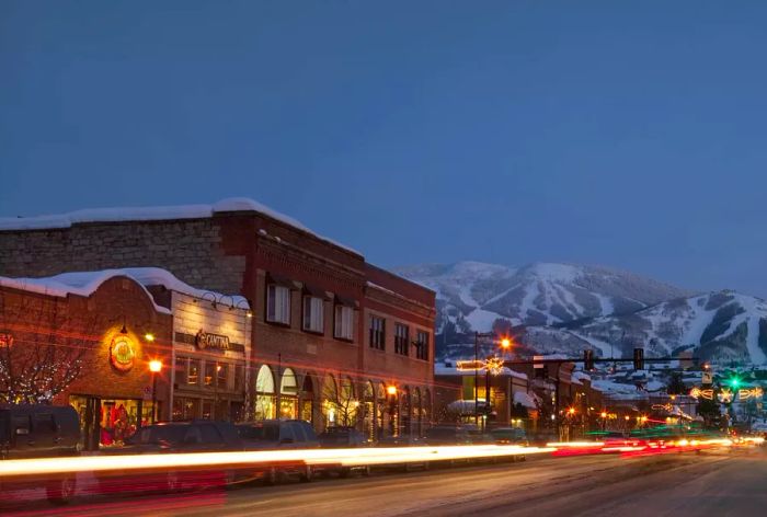 Downtown Steamboat Springs at twilight with a snowy mountain backdrop