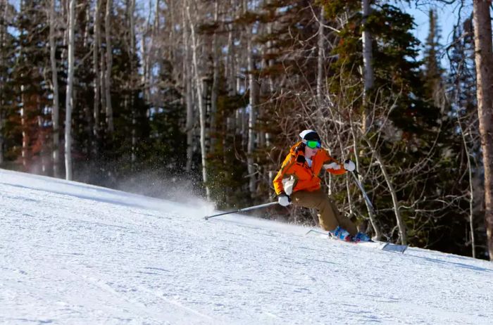 A young skier speeds down the slopes, carving sharp turns at Deer Valley, Utah.