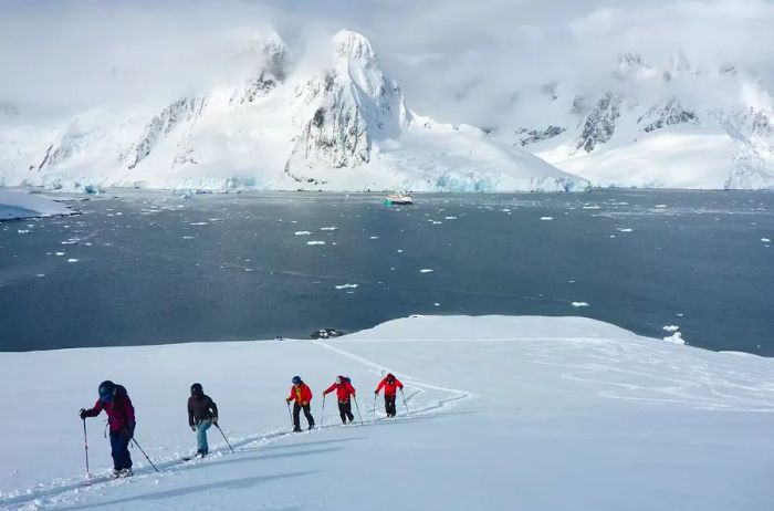 A group skiing in Hovgaard, Antarctica.