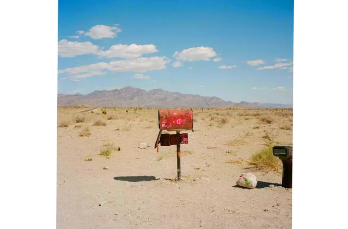 A quirky mailbox positioned by the roadside in the desert