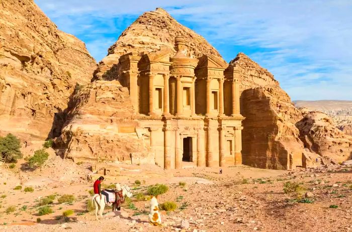 View of a man on horseback in front of Petra