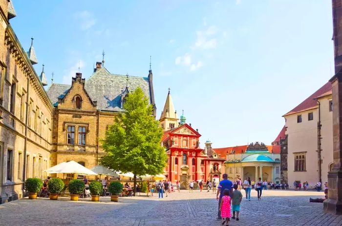 Visitors exploring the grounds of Prague Castle, the official residence of the President of the Czech Republic