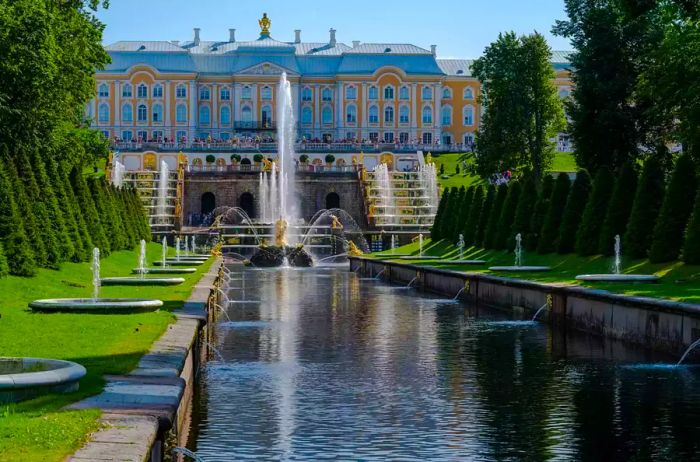 An image showcasing the fountain and gardens leading to the Summer Palace of Peter the Great.