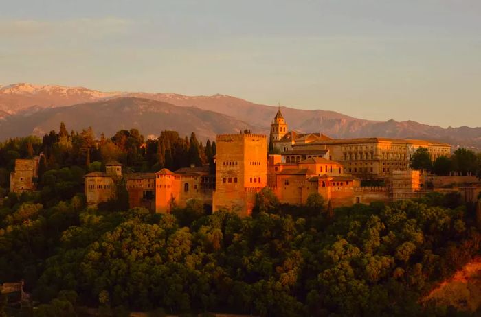 View of Alhambra on a hill during sunset