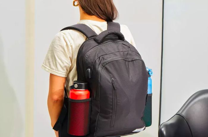 Rear view of an individual wearing the Solo Re:Define Backpack