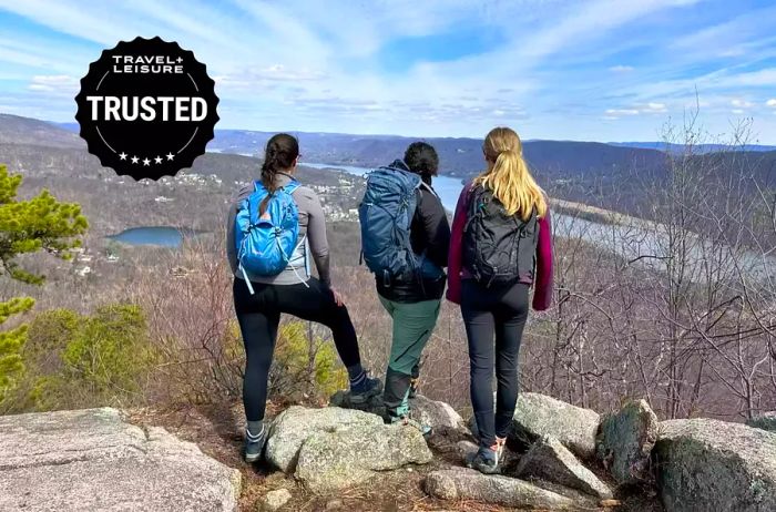 Three women hiking with backpacks on a mountain