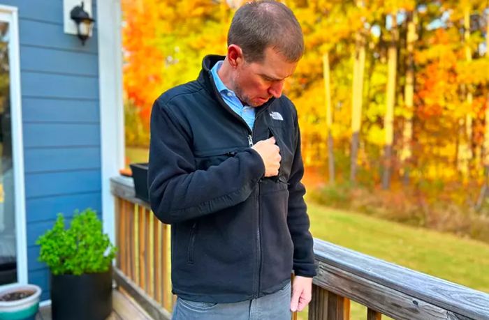 A man zipping up his fleece jacket