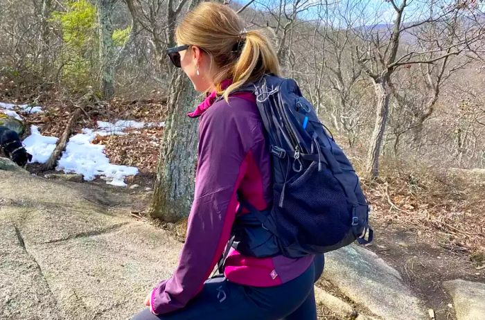 A person hiking outdoors with the Gregory Women's Swift 22 H20 Backpack