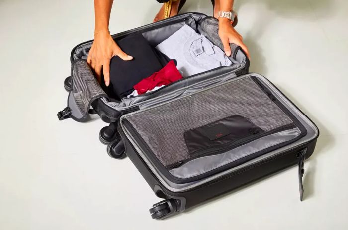 Tumi Alpha International Dual Access 4 Wheeled Carry-On packed with clothing