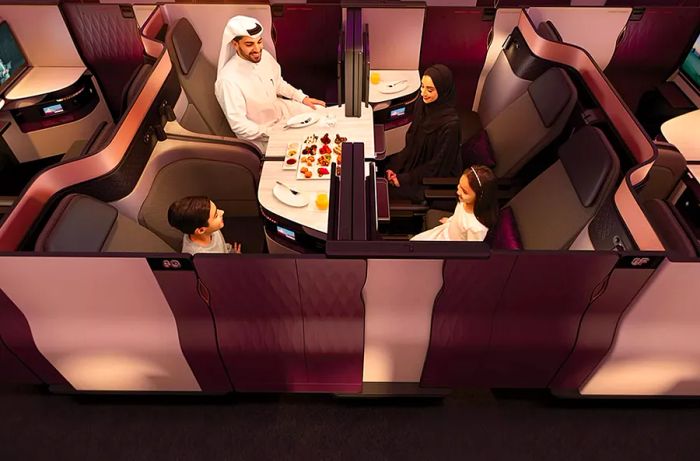 Family enjoying the Q-Suite experience on Qatar Airways