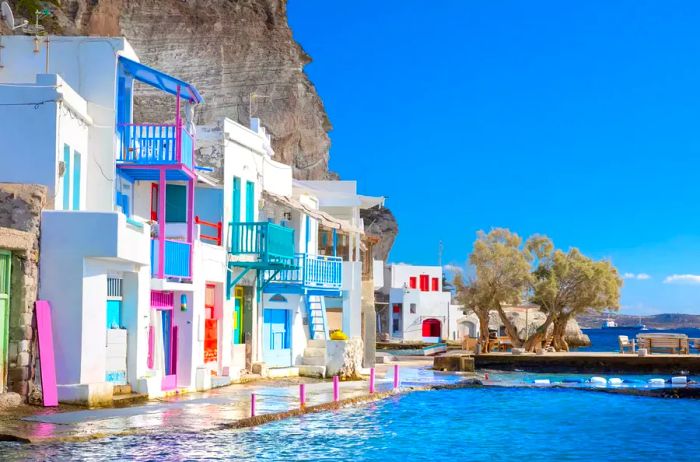 The lively fishing village of Klima features white houses with vibrant doors on Milos Island in Greece. High-quality photo.