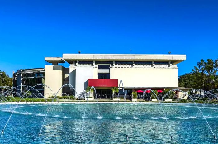 The Roux Library, crafted by Nils Schweizer, and the Waterdome, designed by Frank Lloyd Wright, serve as significant architectural highlights for Florida Southern College.