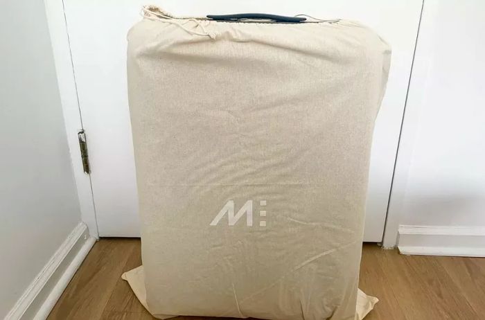 The Monos Check-in Medium stored in a dust bag