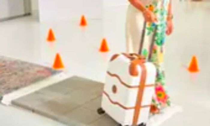 A woman rolls the Delsey CHATELET AIR 2.0 CARRY-ON - 21