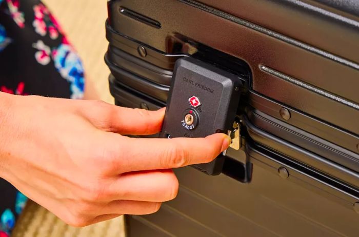 A person interacts with the lock on the Carl Friedrik Trunk