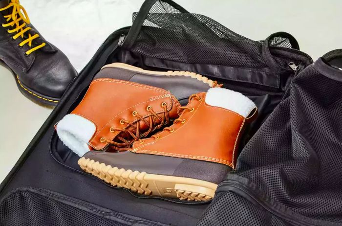 Boots stored inside the Ogio Terminal Travel Bag