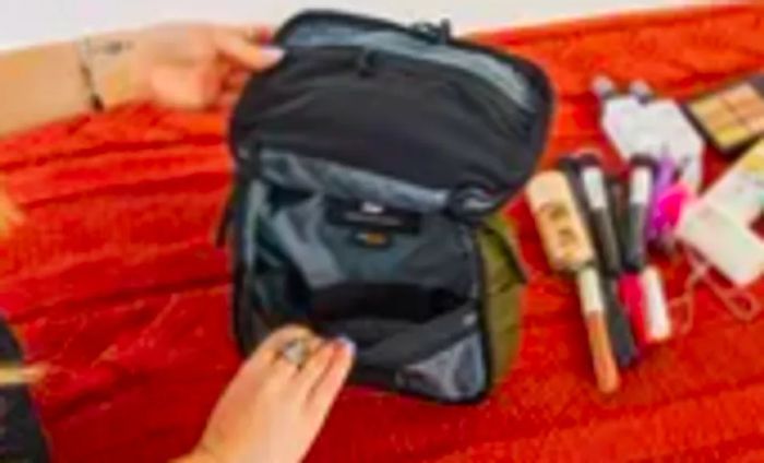 A person unzips the Aer Travel Kit 2