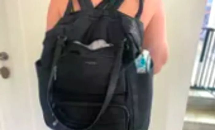 A person sporting a black backpack