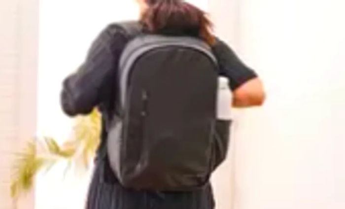 A person is seen wearing the Stubble & Co. The Everyday Backpack