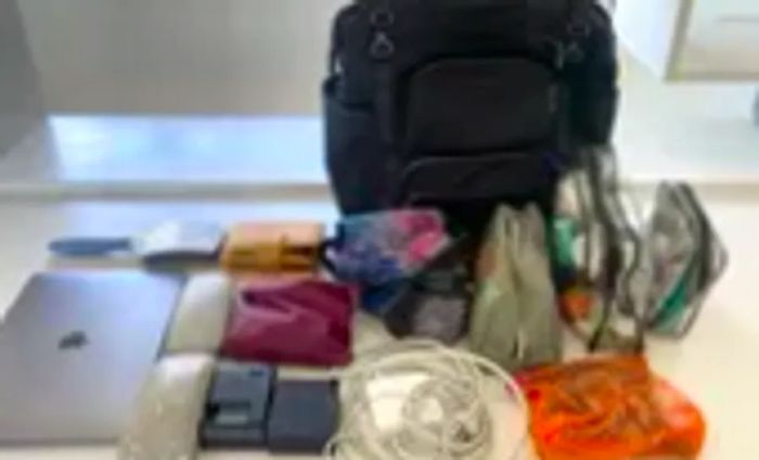 A black backpack positioned among various items