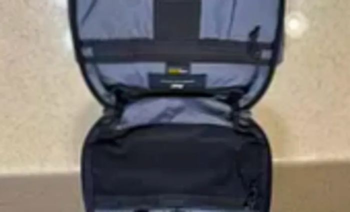 The Aer Travel Kit 2 is unzipped and laid open on a counter