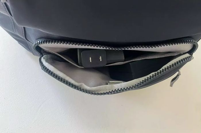 An interior pocket of a black backpack