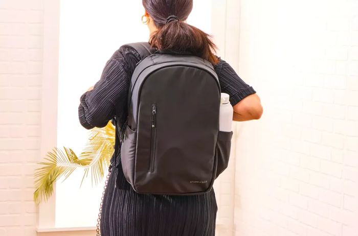 A person is seen wearing the Stubble & Co. The Everyday Backpack