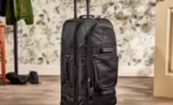 Ogio Terminal Travel Bag presented upright against a floral wallpaper