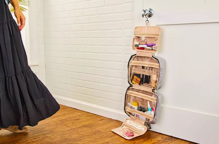 The Bagsmart Toiletry Bag with Hanging Hook displayed hanging from a doorknob