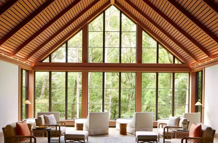 Spa lounge area featuring large windows with a view of the forest