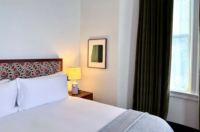 Interior view of the guest room featuring a bed by the window.