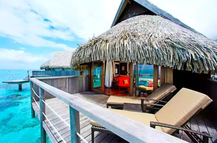 A stunning exterior view of an overwater bungalow at Sofitel Kia Ora Moorea.