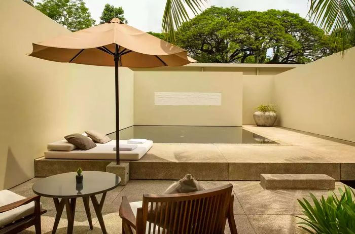 The pool suite at Amansara features a private plunge pool and lounge chairs for relaxation.