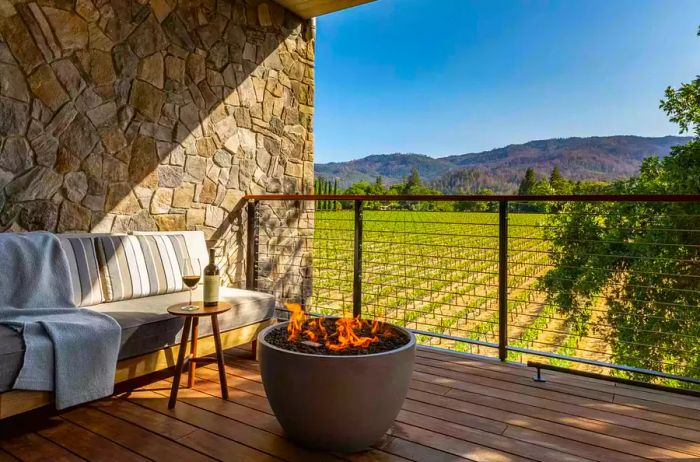 A terrace featuring a firepit and stunning views of the vineyards at Alila Napa Valley