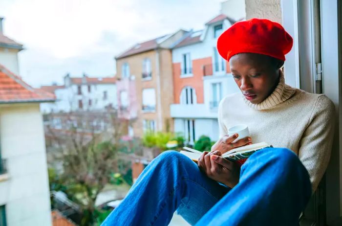 A young woman enjoying a book by the window