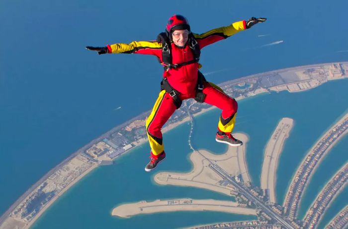 A woman free-falling while skydiving over Dubai's Palm Jumeirah