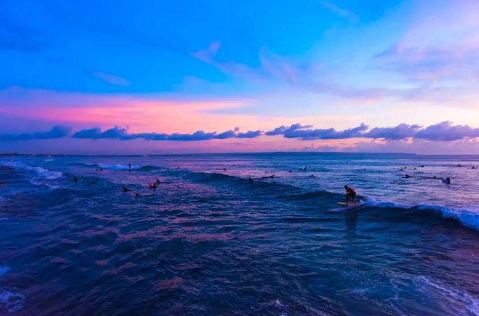 Surfing at Batu Bolong Beach in Canggu, Bali, Indonesia.