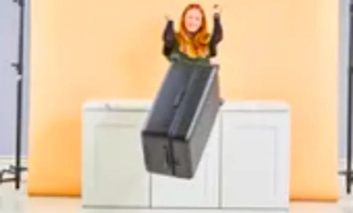 A person sliding the Away The Trunk off a counter