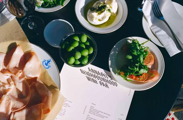 A menu, snacks, and wine displayed on the table at Annabel's wine bar in Auckland, New Zealand