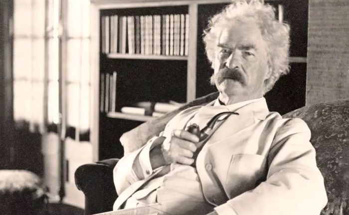 A portrait of Mark Twain seated comfortably, pipe in hand.