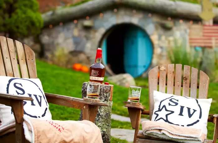 Relax with chairs and a bottle of Maker's Mark outside the Hobbit House at The Preserve Sporting Club & Residences.