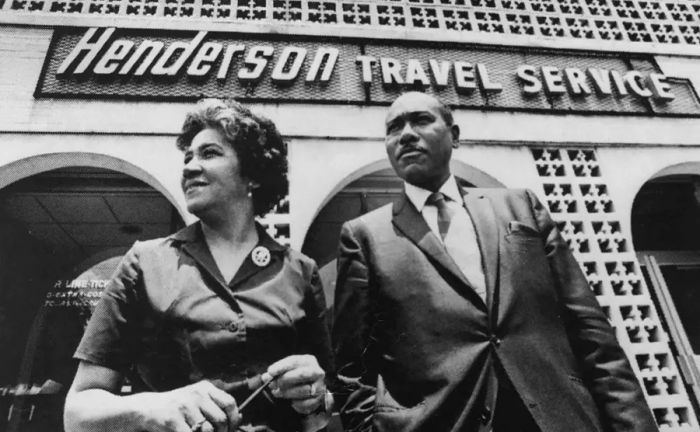 Freddye and Jake Henderson stand proudly outside Henderson Travel in Atlanta, the inaugural accredited African-American-owned travel agency in the United States, established in 1955.